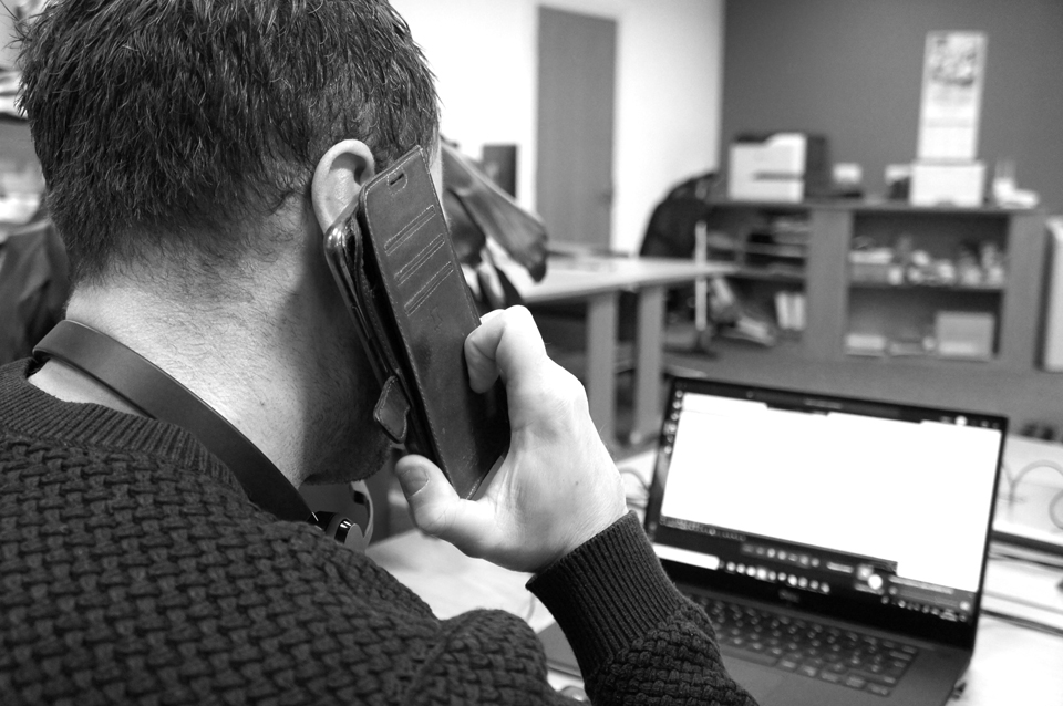 a man on the phone talking to a Managed Services Client