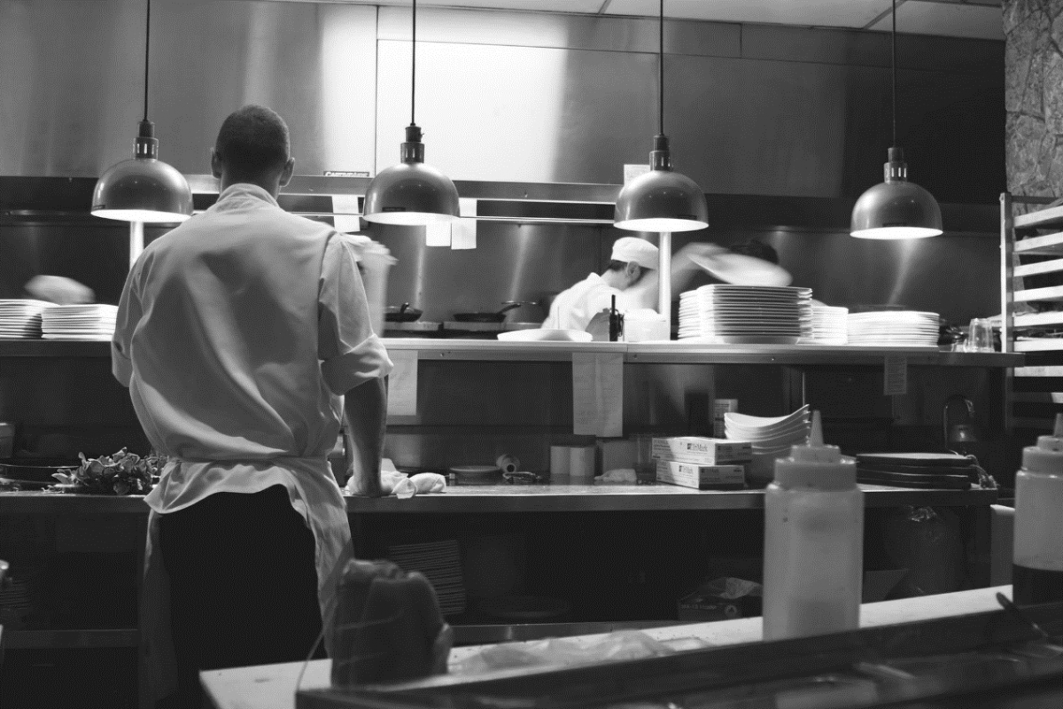 chefs cooking food in a restaurant