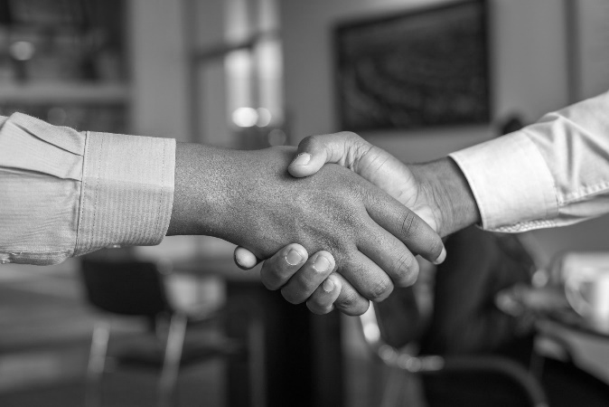 two men shaking hands making a deal