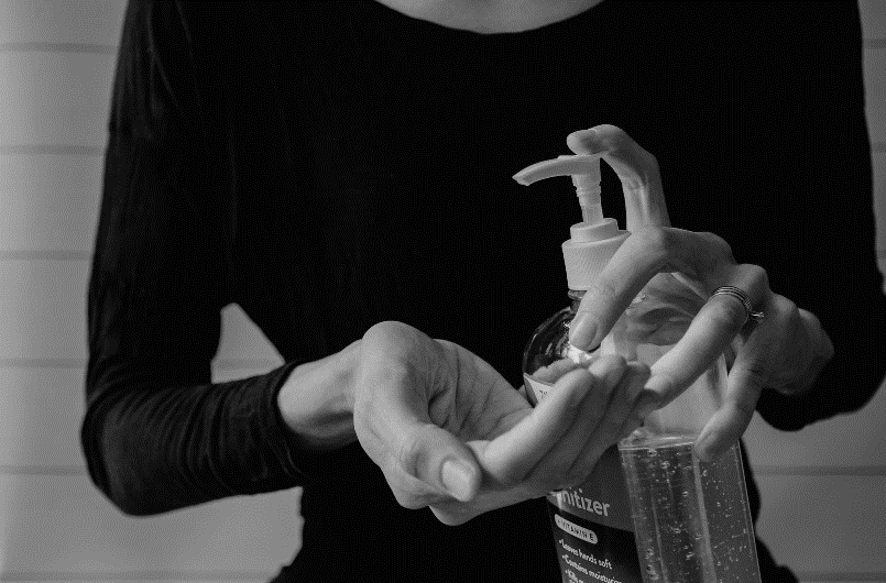 a women sanitising her hands